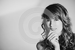 Portrait of a 36 year old woman with curly hair and brown slanting eyes. Soft selective focus. Black and white art photo