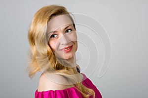 Portrait of a 39 year old woman in pink dress