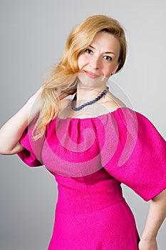 Portrait of a 39 year old woman in pink dress