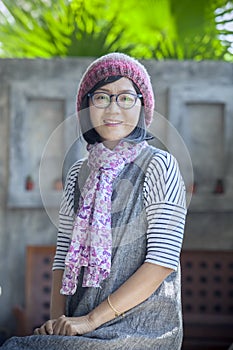 portrait of 40s years asian woman wearing wool hood and silk scarf toothy smiling with happiness emotion