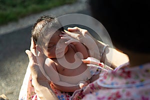 A portrait of a 42-day-old boy born in a lotus birth with her mother. Unlike babies in general, the baby`s umbilical cord is left