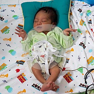 A portrait of a 42-day-old boy born in a lotus birth. Unlike babies in general, the baby`s umbilical cord is left to join with th