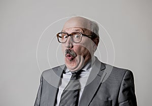 Portrait of 60s bald senior happy business man gesturing funny and comic in laughter and fun face expression looking happy