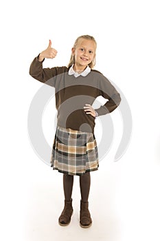 Portrait of 7 or 8 years old beautiful and happy schoolgirl female child in school uniform smiling cheerful isolated on white back