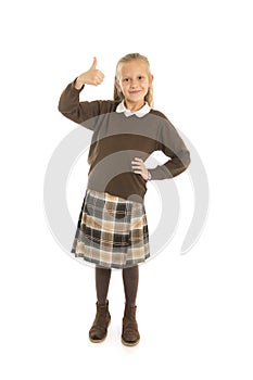 Portrait of 7 or 8 years old beautiful and happy schoolgirl female child in school uniform smiling cheerful isolated on white back