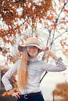 Portrait of abeautiful blonde in a hat on a background of the city of Moscow