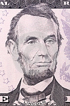 Portrait of Abraham Lincoln on five U.S. dollar bill.