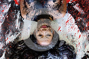 Portrait of abstract painted asian woman in black  white  red  with long hair upside down on studio floor  creative  abstract body