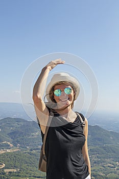 Portrait of active blond caucasian girl at Dentelles de Montmirail chain of mountains in Provence in Vaucluse, France