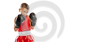 Portrait of active boy, beginner boxer in sports gloves and red uniform isolated on white background. Concept of sport