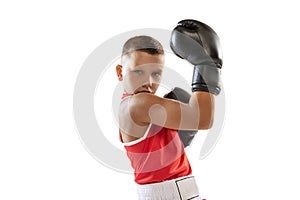 Portrait of active boy, beginner boxer in sports gloves and red uniform isolated on white background. Concept of sport