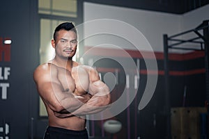 Portrait of Active healthy sport male or athlete showing muscles and biceps on arms. Big Bodybuilder guy showing his physical form
