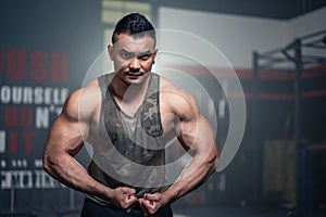 Portrait of Active healthy sport man showing muscles and biceps on arms. Big Bodybuilder guy or athlete showing his physical form