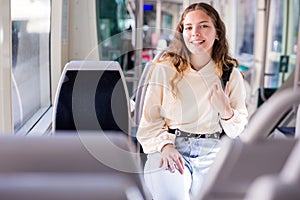 Portrait of a positive girl riding on public transport photo
