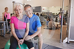 Portrait Of Active Senior Couple Exercising In Gym Together