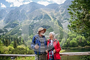 Portrét aktívneho staršieho páru na spoločnej turistike v jesenných horách.