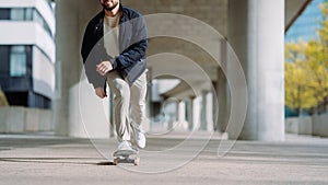 Portrait of active skater boy balancing on skateboard on urban background Focused skateboarder moving on skate board