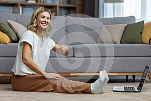 Portrait of active woman at home doing fitness and exercise and yoga, mature housewife looking at camera and smiling