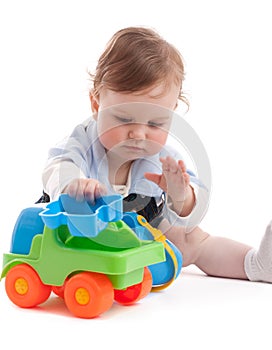 Portrait of adorable baby boy playing with toys