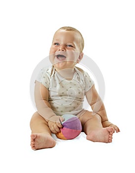 Portrait of adorable baby boy siting on the floor, smiling and having fun with colorful ball. Isolated on white background,