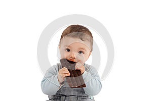 Portrait of an adorable baby eating a chocolate bar