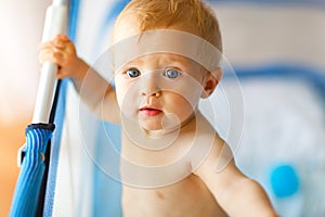 Portrait of adorable baby in playpen