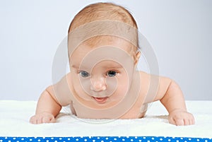 Portrait of adorable baby on white blanket