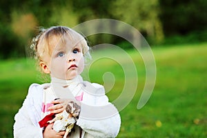Portrait of adorable child girl playing outdoors