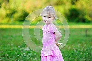 Portrait of adorable child girl walking outdoors