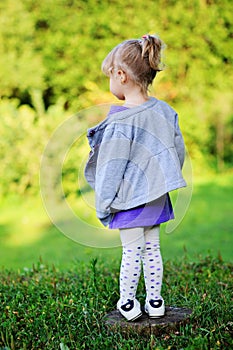 Portrait of adorable child girl walking outdoors