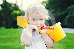 Portrait of adorable child with toys for sand