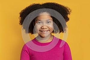 Portrait Of Adorable Curly Little Black Girl Smiling At Camera