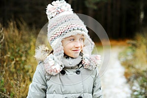 Portrait of adorable girl outdoor in winter park
