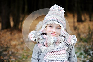 Portrait of adorable girl outdoor in winter park