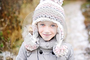 Portrait of adorable girl outdoor in winter park