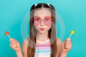 Portrait of adorable girl pouted lips hands hold lollipop candy stick isolated on bright turquoise color background