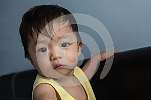 Adorable and happy Chinese 1 year old baby boy child playing on bed