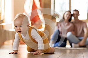 Portrait Of Adorable Infant Baby Crawling On Floor At Home