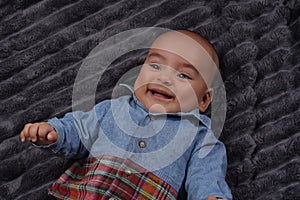 Portrait of adorable infant boy laughing with copy space