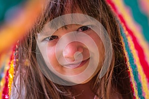 Portrait of adorable kid playing under blanket. Lifetime moments and happy childhood concept. Close up