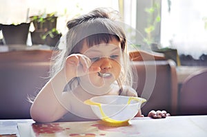 Portrait of adorable little girl having lunch