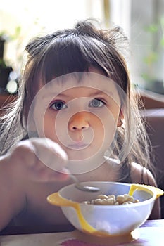 Portrait of adorable little girl having lunch