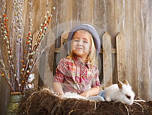 Portrait of an adorable little girl and little white rabbit. Easter concept