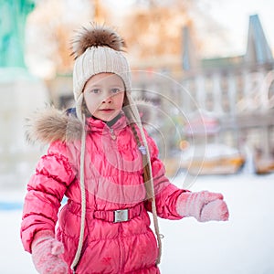 Portrait of adorable little girl on skating rink