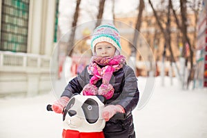 Portrait of adorable little girl on skating rink