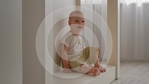 Portrait Of Adorable Little Infant Baby Boy Sitting Alone In Home Interior