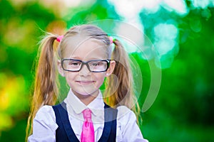 Portrait of adorable little school girl in glasses