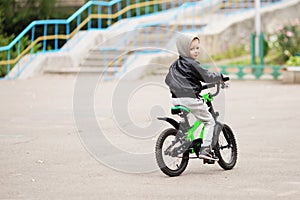 Portrait of adorable little urban boy wearing black leather jack