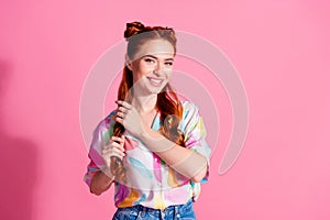 Portrait of adorable pretty woman hands hold foxy curl wear print shirt after beauty salon isolated on pink color