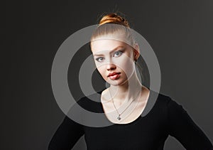 Portrait of a adorable red-haired girl with plump lips.